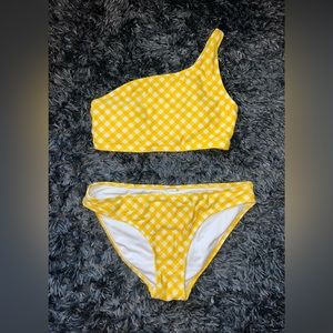 A one shouldered bikini with a checkered pattern both medium top and bottom